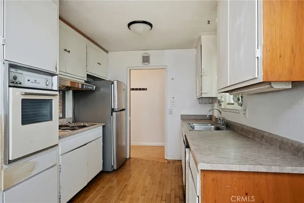 a kitchen that has a microwave a sink and a stove