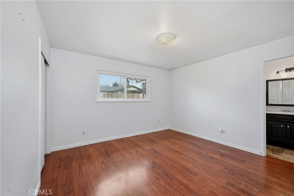 15050 Lakeview Way Clearlake, CA 95422 - Photo 14 of 24 an empty room with wooden floor and windows
