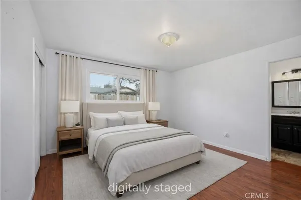 a bedroom with a bed and a night stand