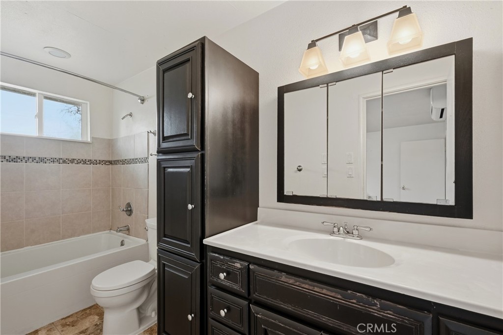 15050 Lakeview Way Clearlake, CA 95422 - Photo 16 of 24 a bathroom with a sink a toilet and shower