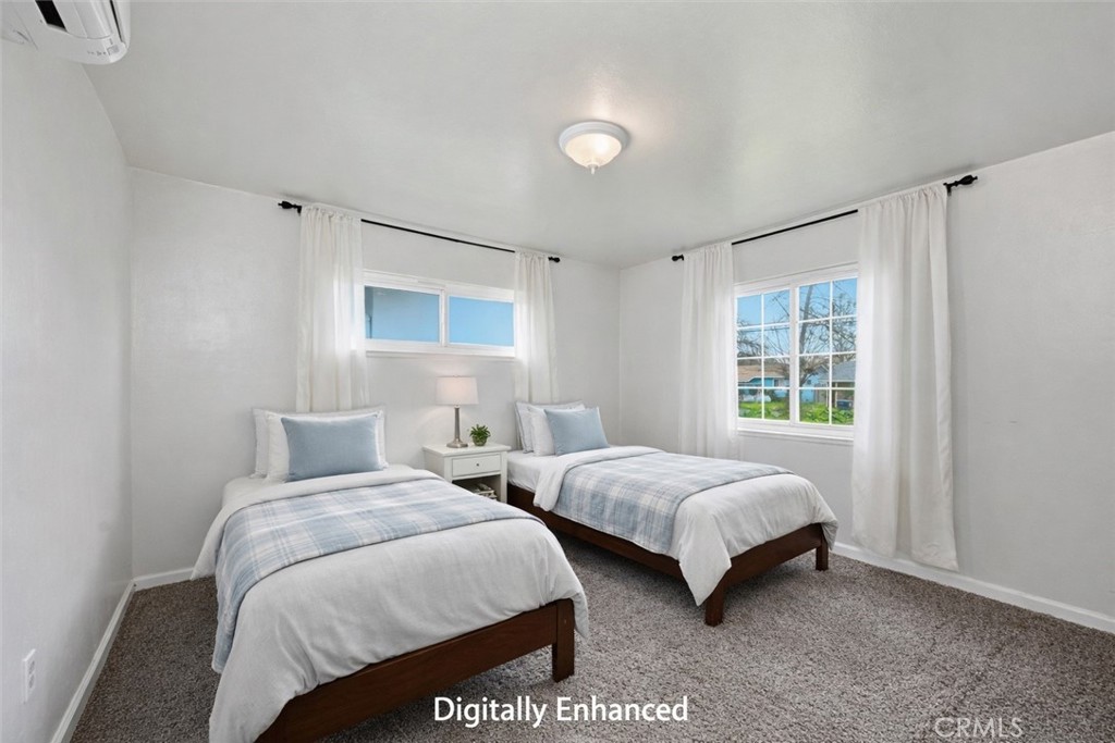 15050 Lakeview Way Clearlake, CA 95422 - Photo 21 of 24 a bedroom with two beds and a window