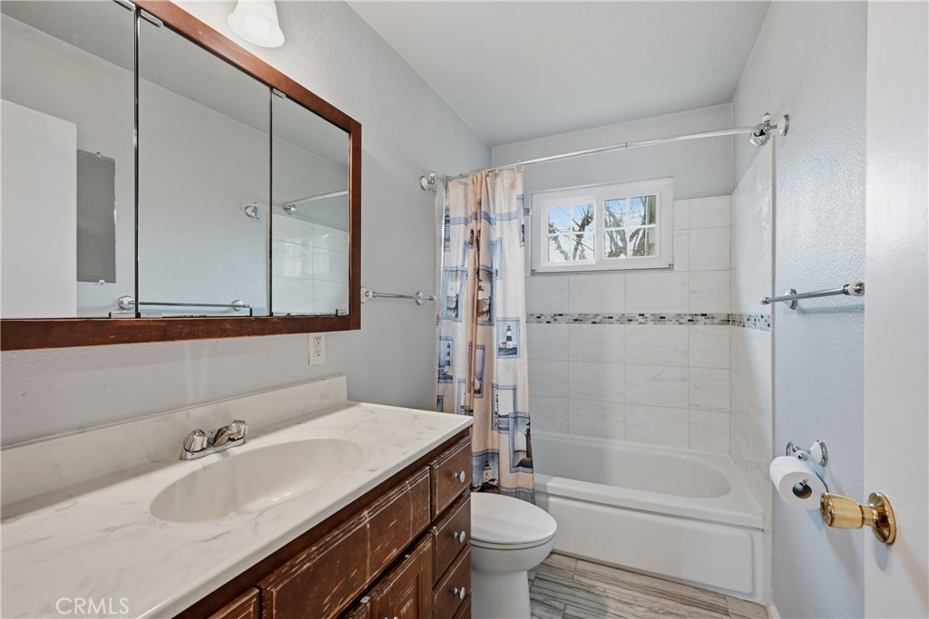 15050 Lakeview Way Clearlake, CA 95422 - Photo 22 of 24 a bathroom with a sink a toilet and shower