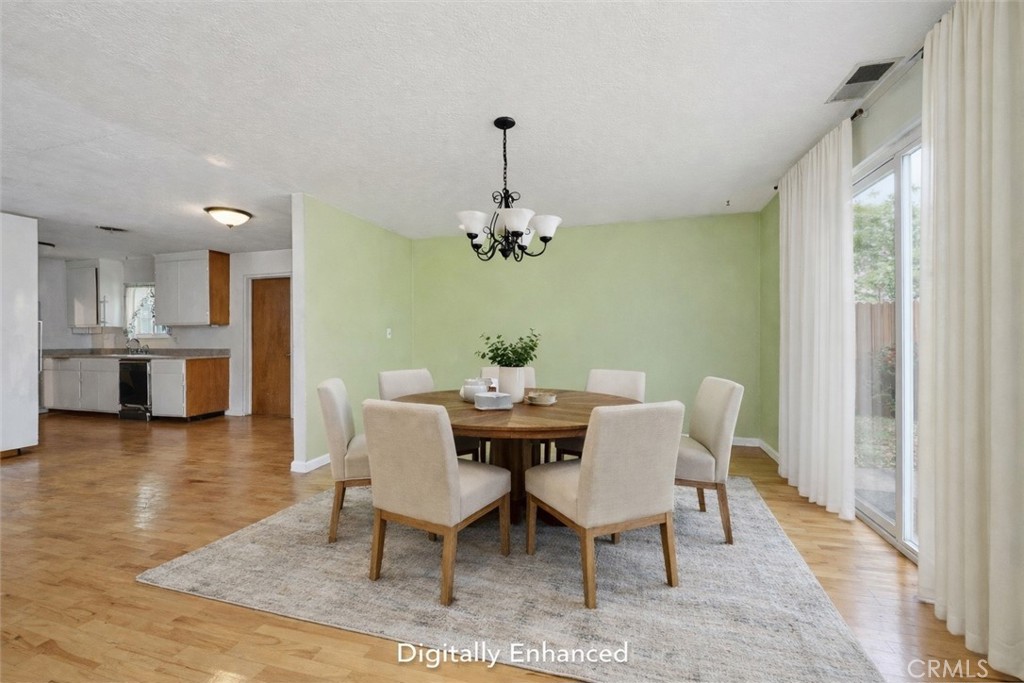 15050 Lakeview Way Clearlake, CA 95422 - Photo 10 of 24 a dining room with furniture wooden floor a chandelier and a rug