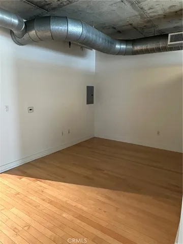 a view of an empty room and wooden floor