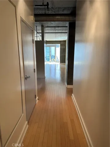 a view of a hallway with wooden floor