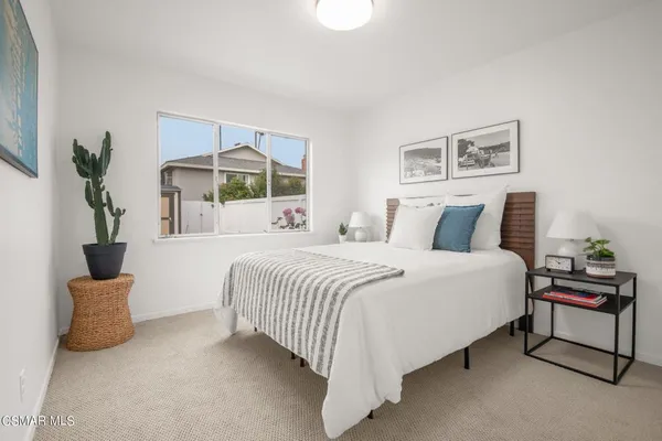 a bedroom with a bed and a painting on the wall