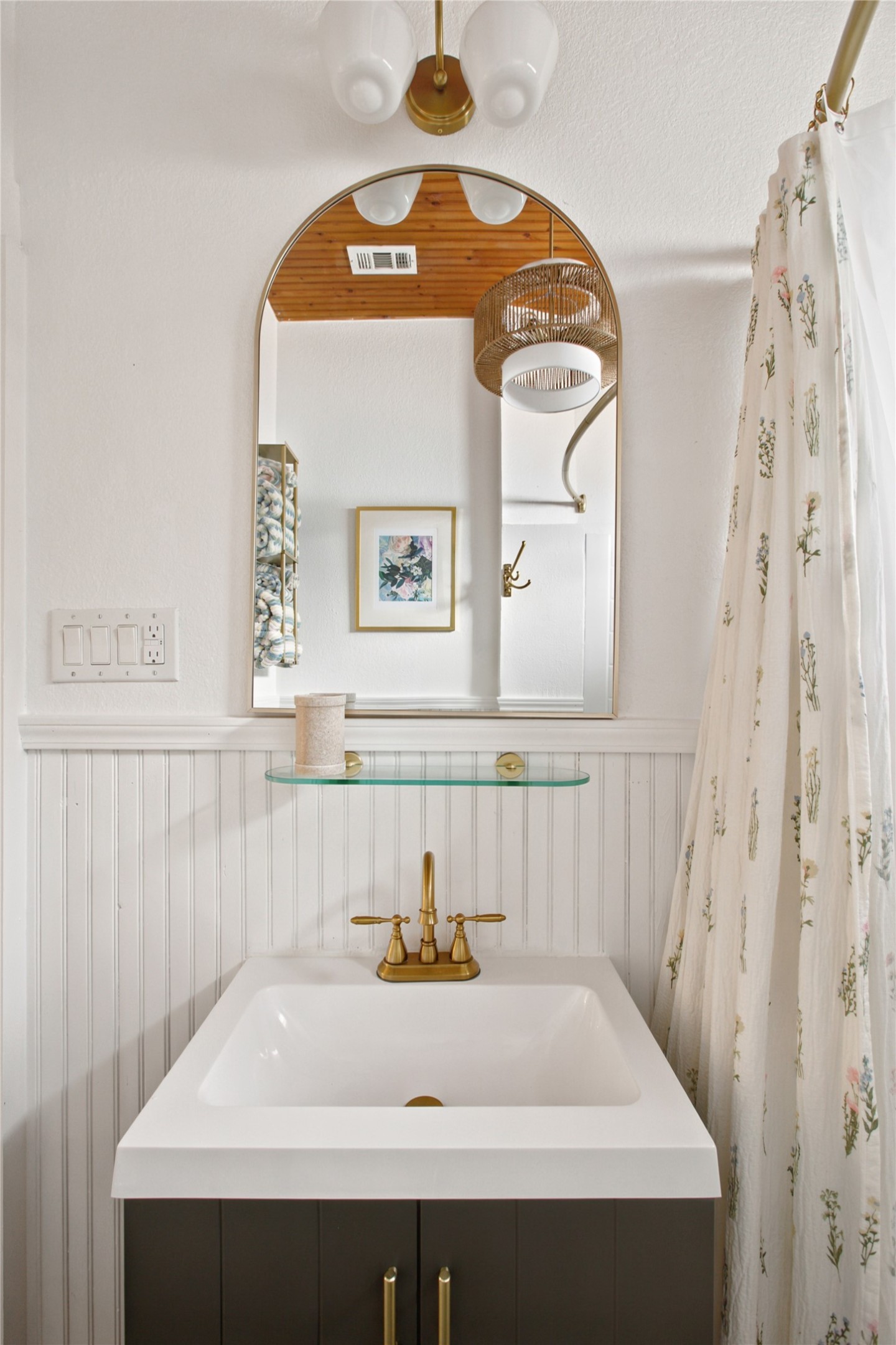 372 Old Lockhart Road Lockhart, TX 78644 - Photo 23 of 40 A compact bath vanity with beadboard paneling and a warm brass faucet, offering practical elegance.