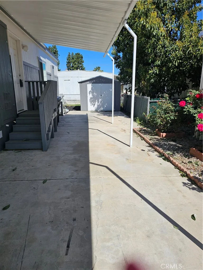 1560 Massachusetts Avenue, Unit 94 Riverside, CA 92507 - Photo 4 of 15 a view of path along with house and car parked