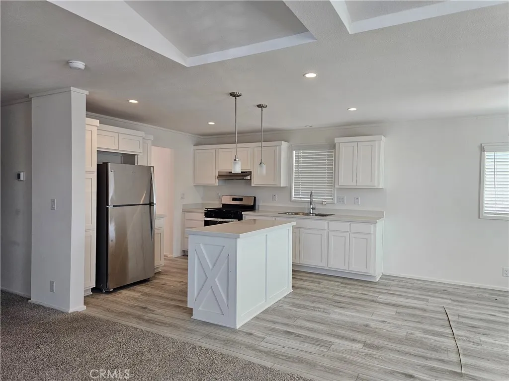1560 Massachusetts Avenue, Unit 94 Riverside, CA 92507 - Photo 6 of 15 a kitchen with stainless steel appliances granite countertop a refrigerator sink and white cabinets