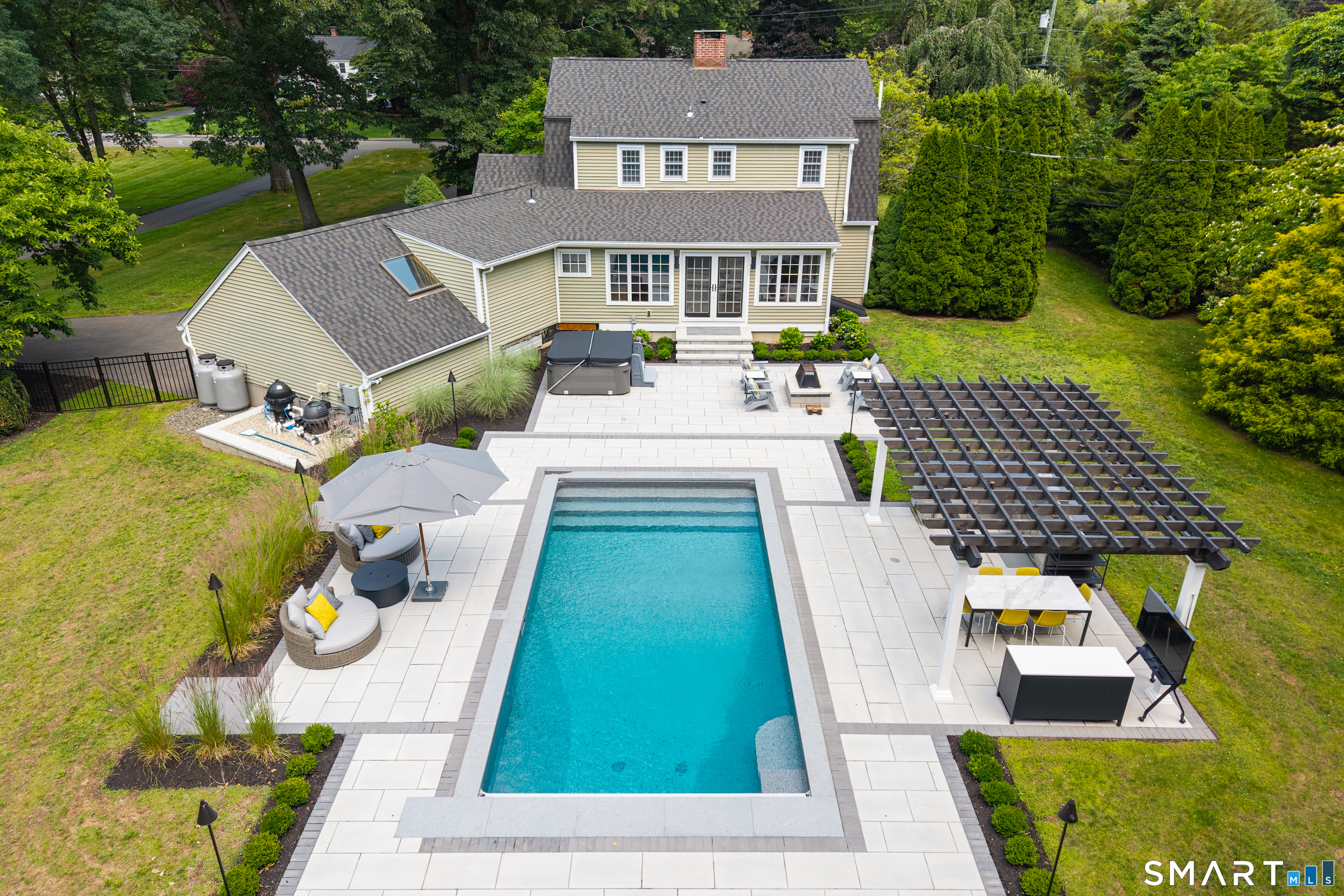 33 River Edge Farms Road Madison, CT 06443 - Photo 2 of 40 Your private backyard retreat was designed for unforgettable entertaining, featuring a heated saltwater pool, premium hardscaping, and beautifully appointed outdoor living spaces.