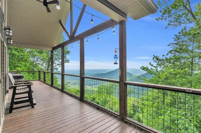 a view of a balcony with chairs and wooden floor