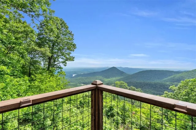 a view of balcony with floor to ceiling windows and wooden fence