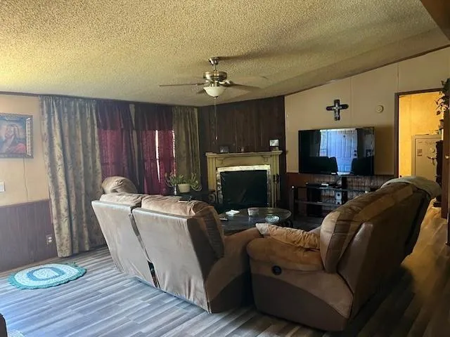 a living room with furniture a fireplace and a flat screen tv