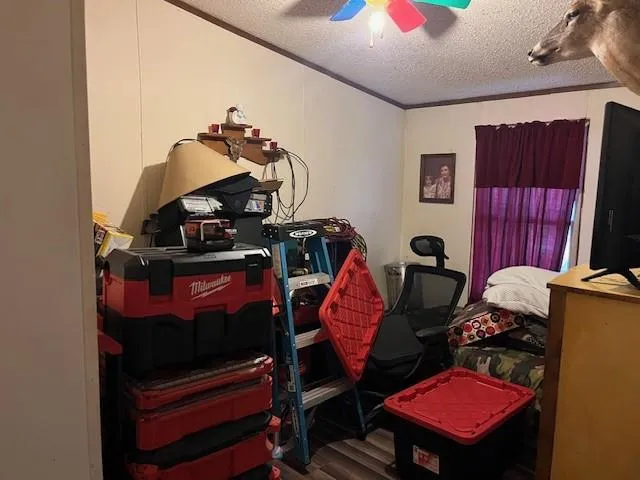 a living room with furniture a flat screen tv and gym equipment