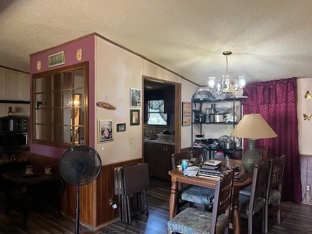 a dining room with furniture and chandelier kitchen view