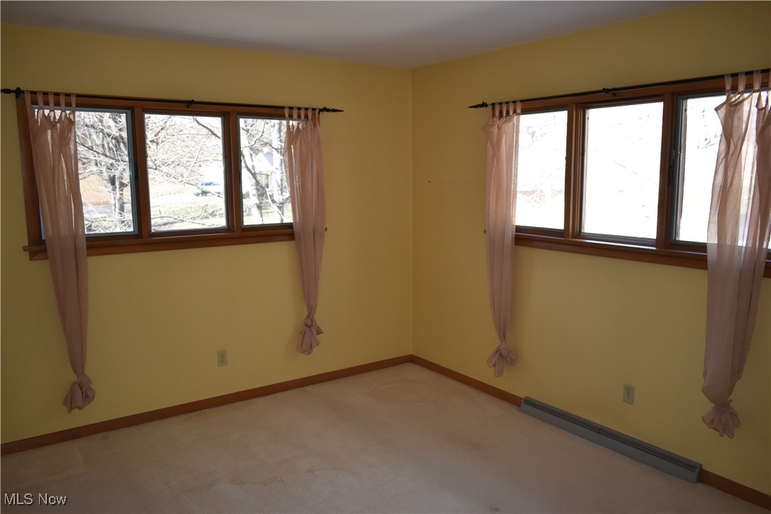 735 Sheridan Road Coshocton, OH 43812 - Photo 25 of 34 Carpeted spare room featuring a baseboard heating unit