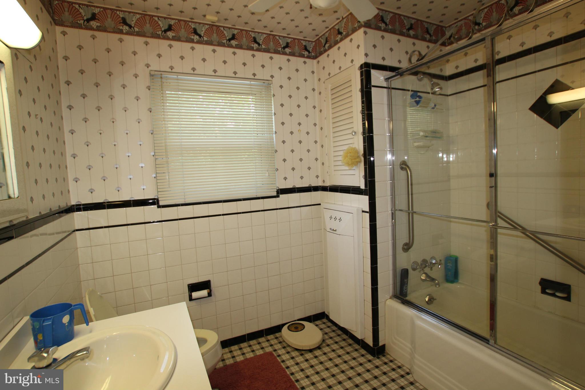 3511 Labyrinth Road Baltimore, MD 21215 - Photo 11 of 20 a bathroom with a sink toilet and shower