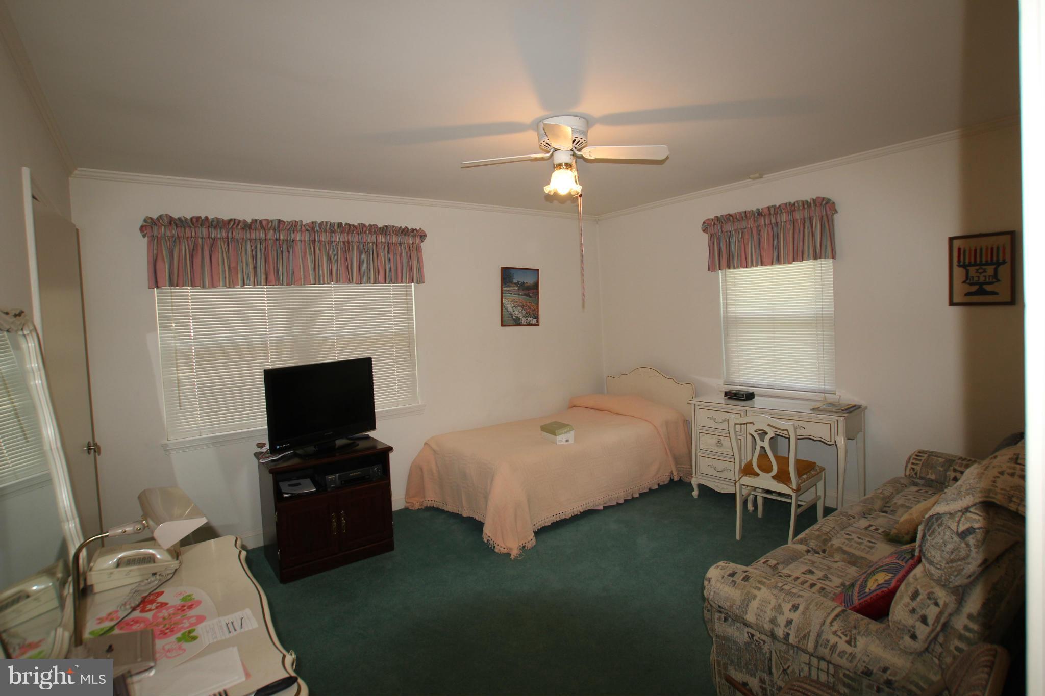 3511 Labyrinth Road Baltimore, MD 21215 - Photo 12 of 20 a bedroom with a bed and a tv
