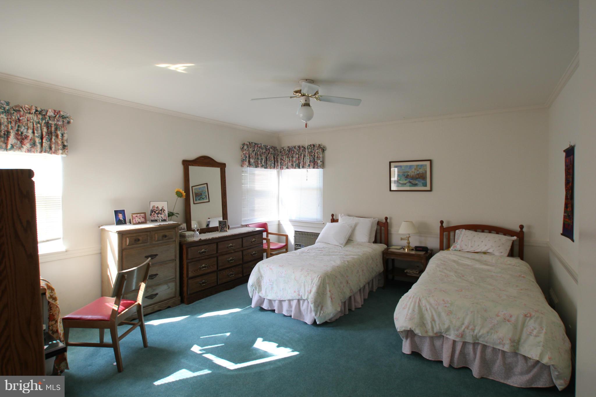 3511 Labyrinth Road Baltimore, MD 21215 - Photo 13 of 20 a bedroom with two beds and windows