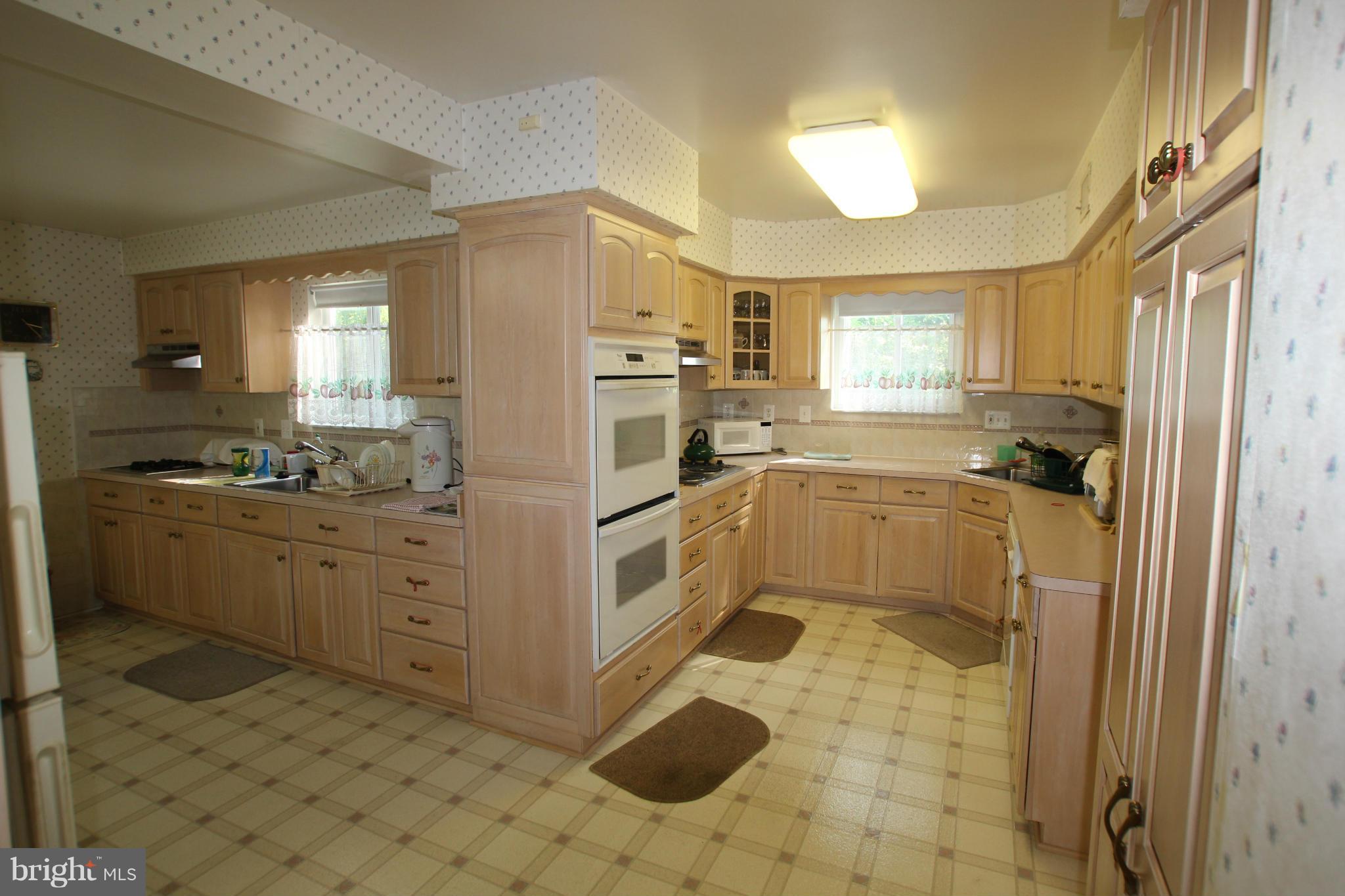 3511 Labyrinth Road Baltimore, MD 21215 - Photo 4 of 20 a kitchen with granite countertop a refrigerator sink stove and cabinets