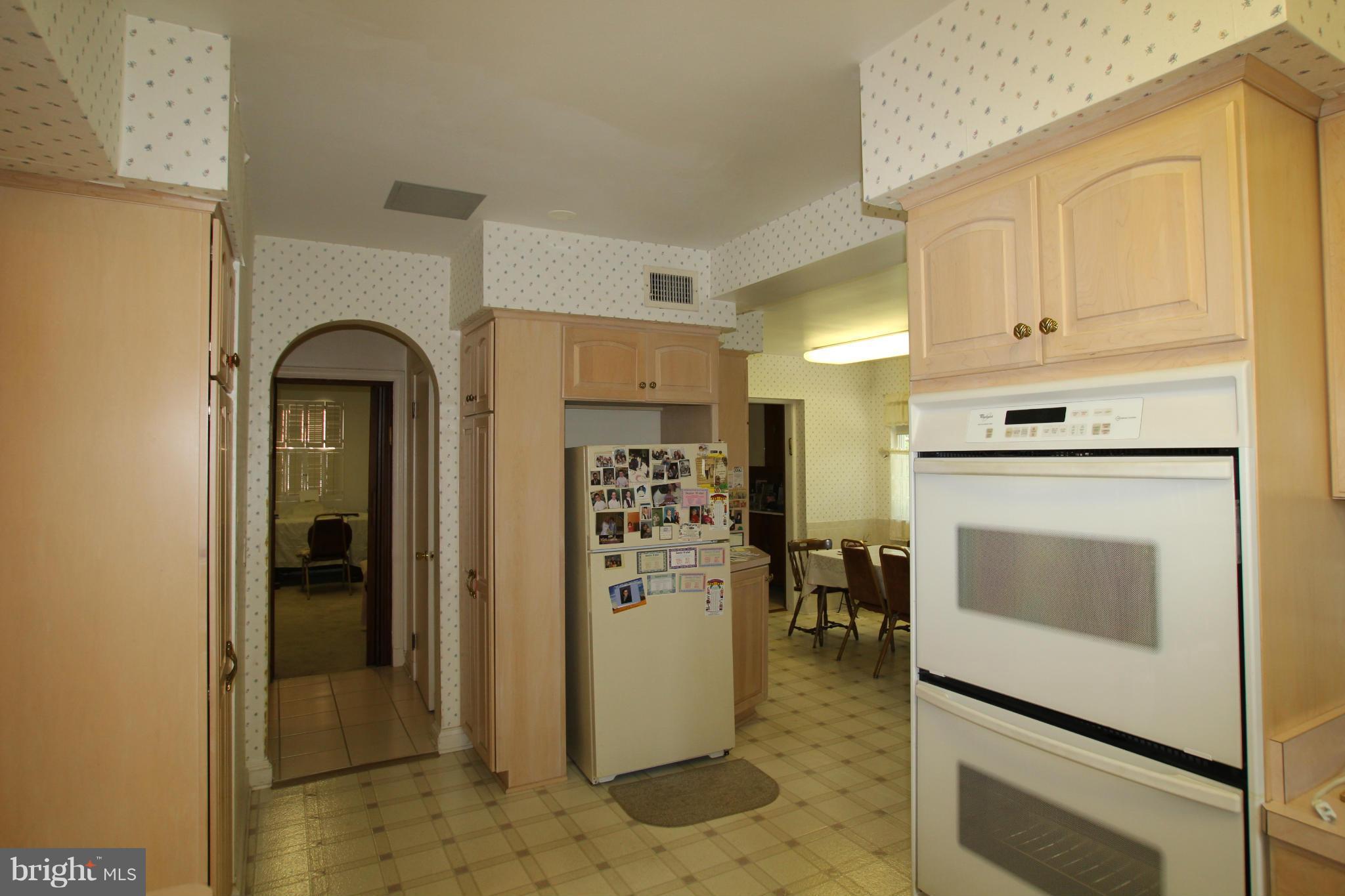 3511 Labyrinth Road Baltimore, MD 21215 - Photo 5 of 20 a view of a kitchen with refrigerator and stove