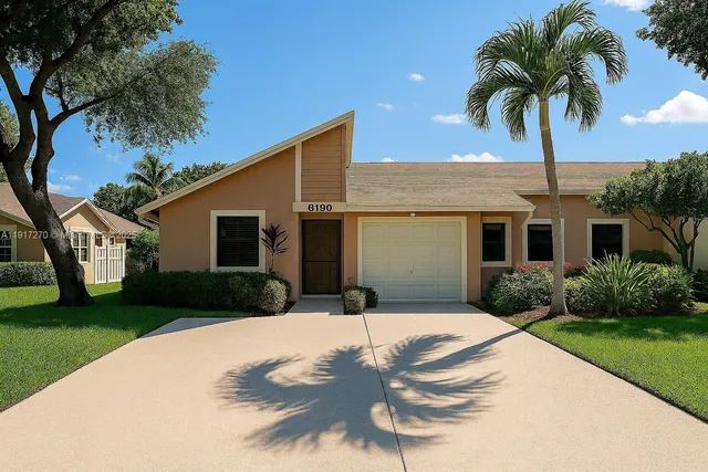 a front view of house with yard and green space