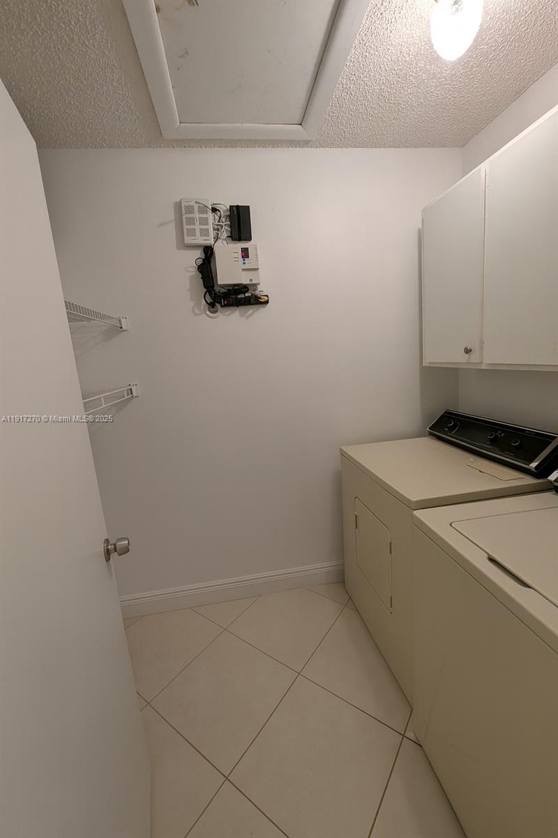 8190 Springtree Road, Unit 8190 Boca Raton, FL 33496 - Photo 13 of 23 a view of storage and utility room with washer and dryer