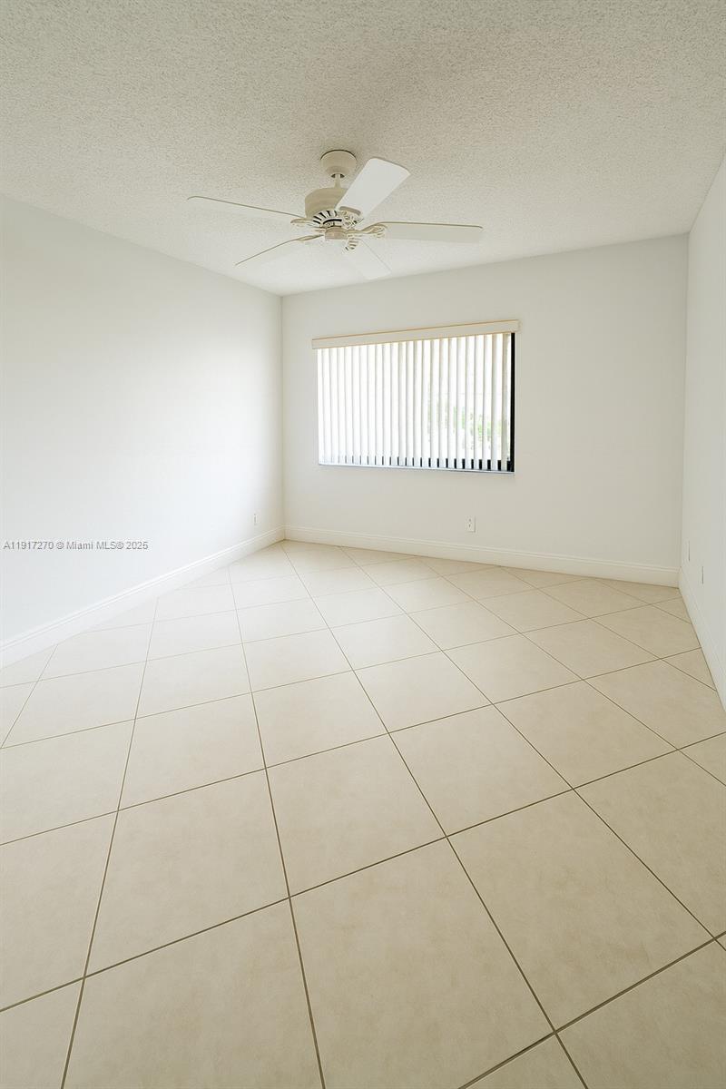 8190 Springtree Road, Unit 8190 Boca Raton, FL 33496 - Photo 14 of 23 a view of an empty room with a window