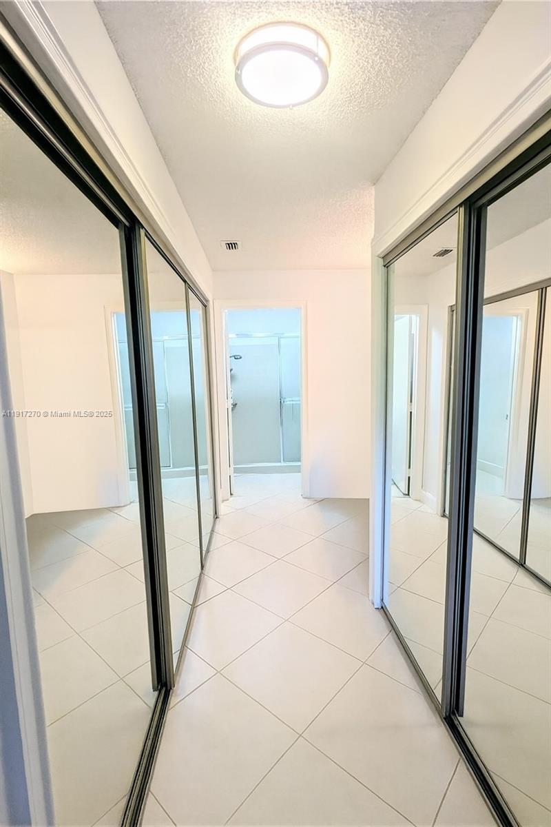 8190 Springtree Road, Unit 8190 Boca Raton, FL 33496 - Photo 16 of 23 a view of a hallway