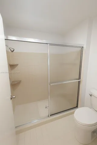 a bathroom with a shower and a toilet