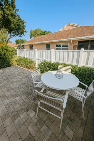 a view of a patio with a table and chairs