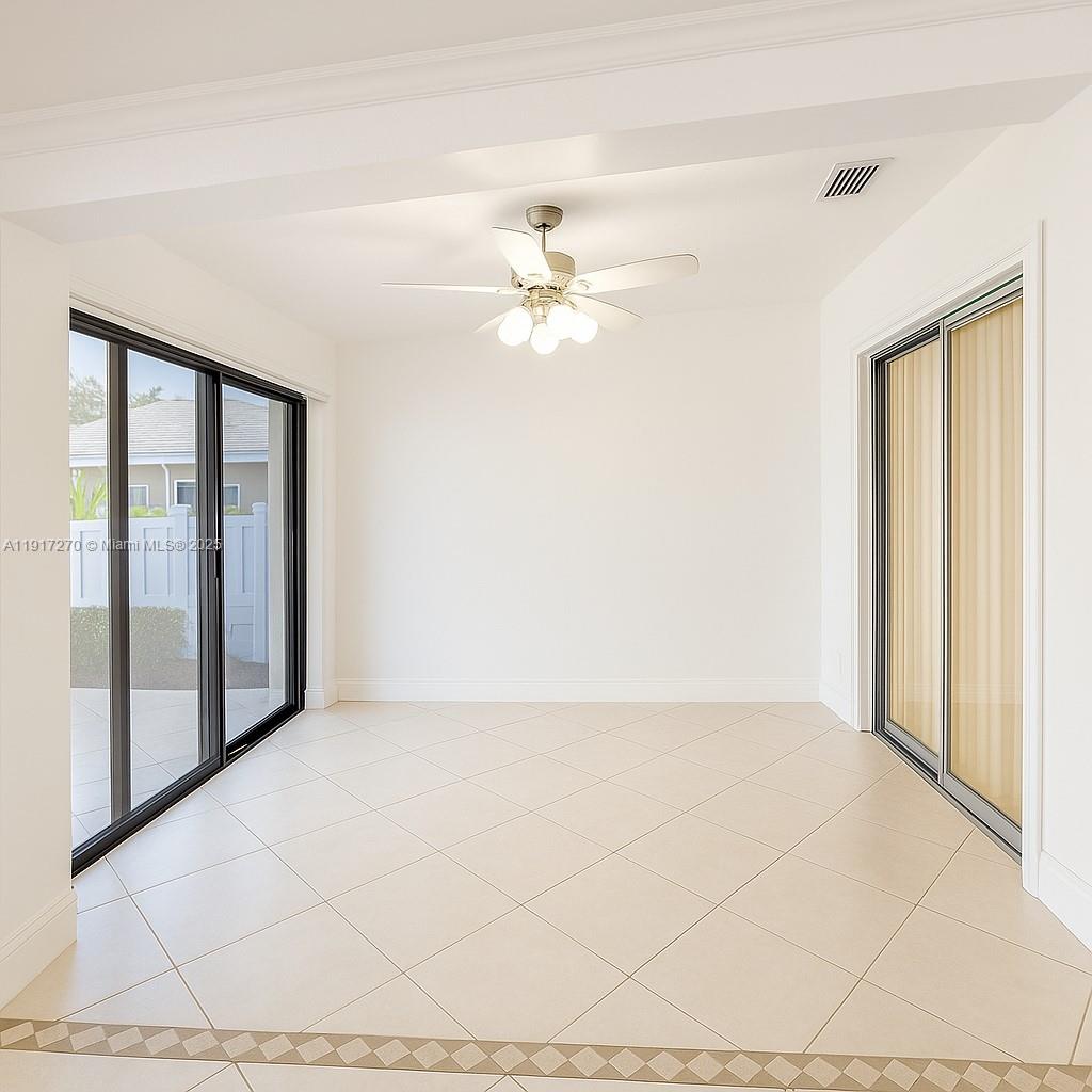 8190 Springtree Road, Unit 8190 Boca Raton, FL 33496 - Photo 8 of 23 an empty room with fan and a ceiling fan