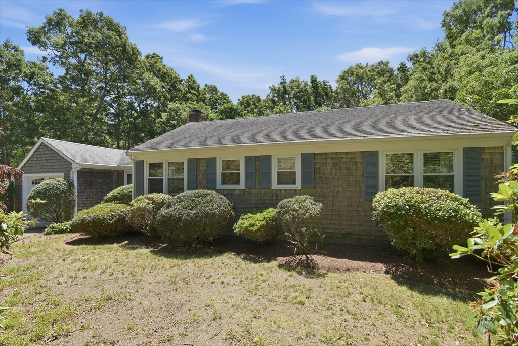8 Emerald Way Sandwich, MA 02644 - Photo 2 of 36 a front view of a house with a yard and potted plants