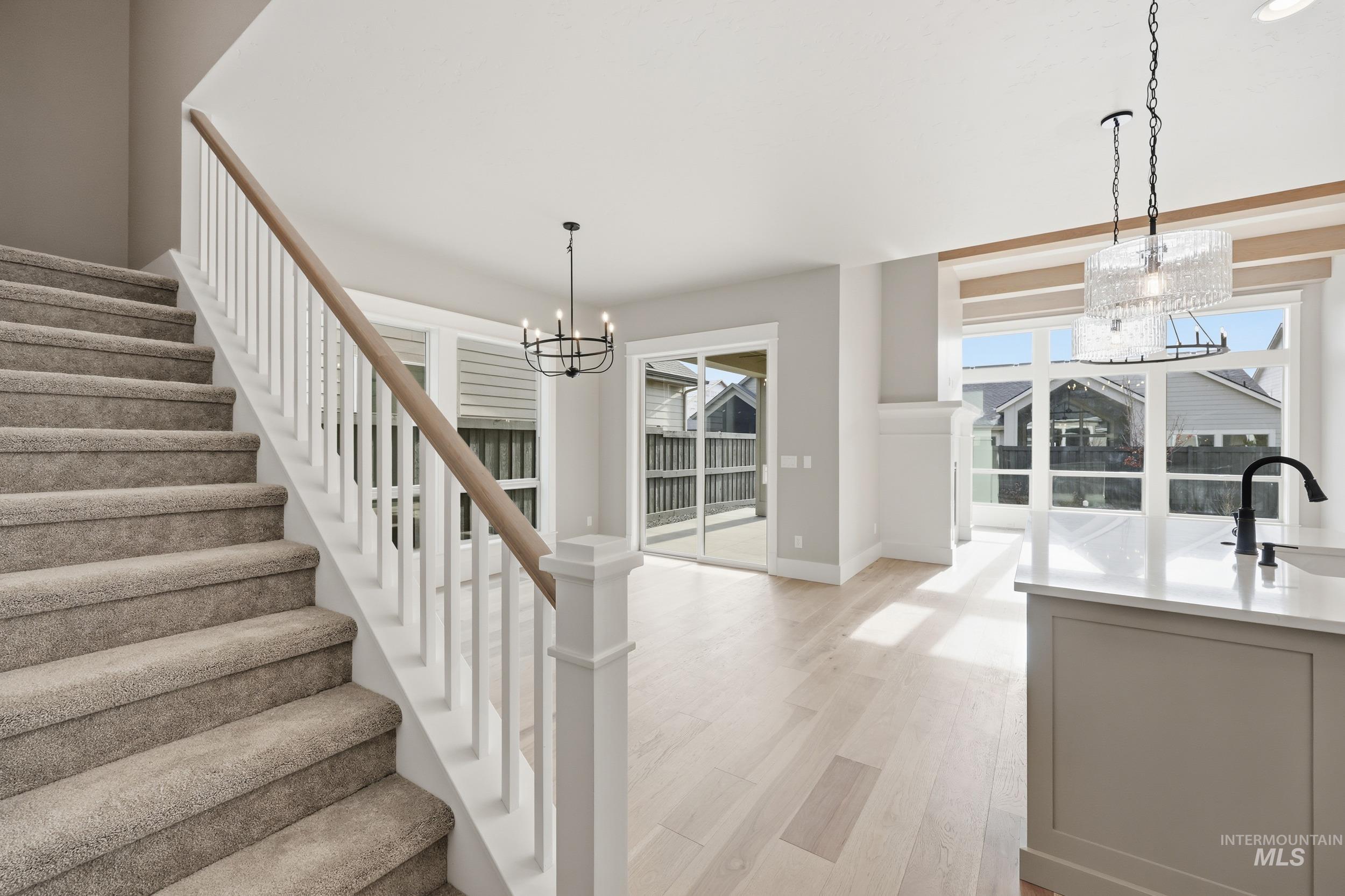 1035 East Crescendo Street Meridian, ID 83642 - Photo 18 of 50 Stairway with a chandelier and wood finished floors