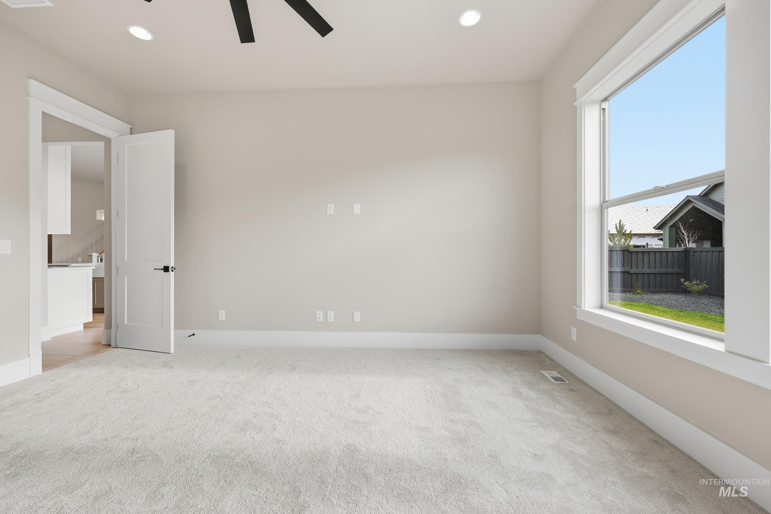 1035 East Crescendo Street Meridian, ID 83642 - Photo 19 of 50 Spare room featuring ceiling fan, light colored carpet, and recessed lighting