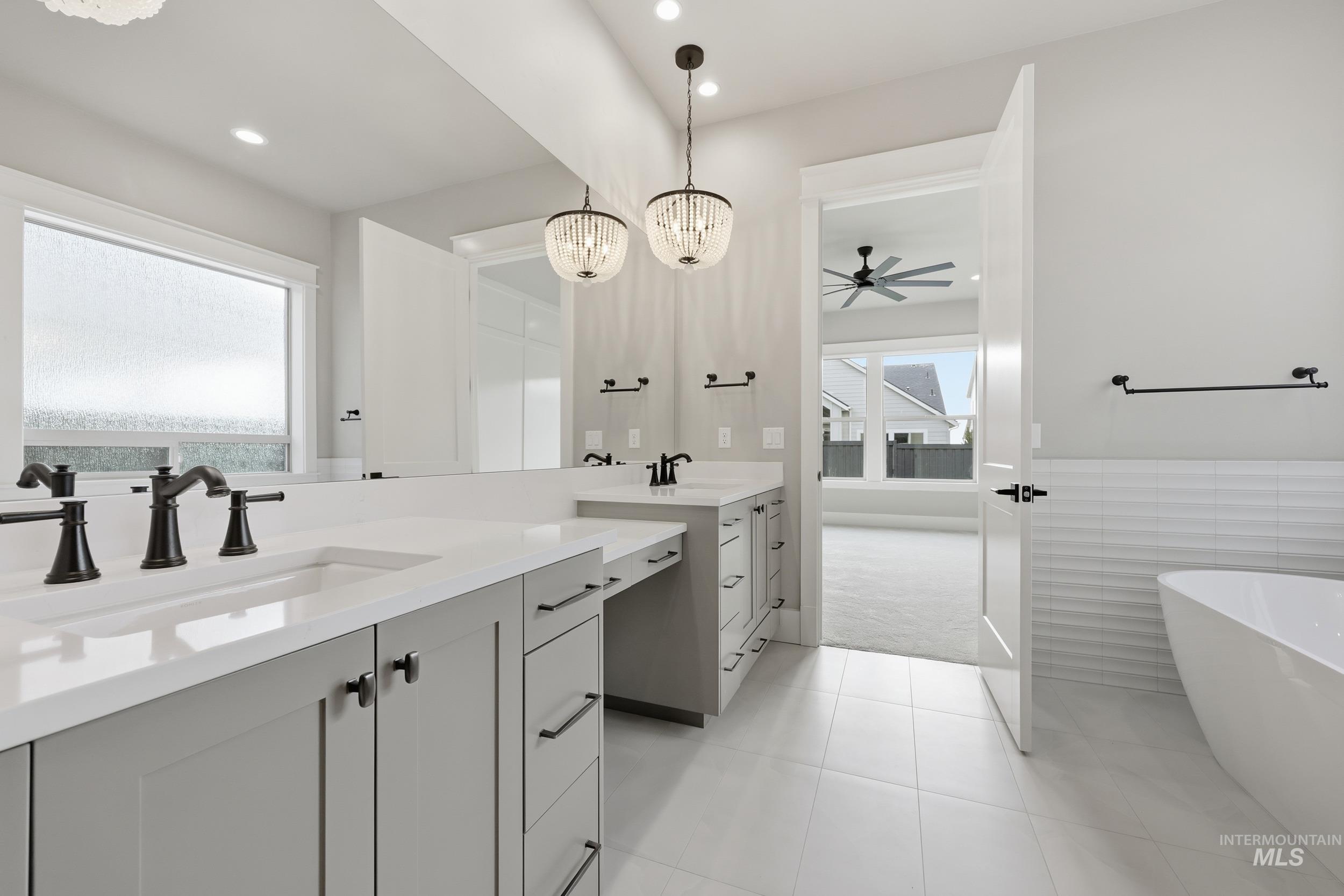 1035 East Crescendo Street Meridian, ID 83642 - Photo 20 of 50 Full bath with a chandelier, a soaking tub, two vanities, recessed lighting, and a ceiling fan