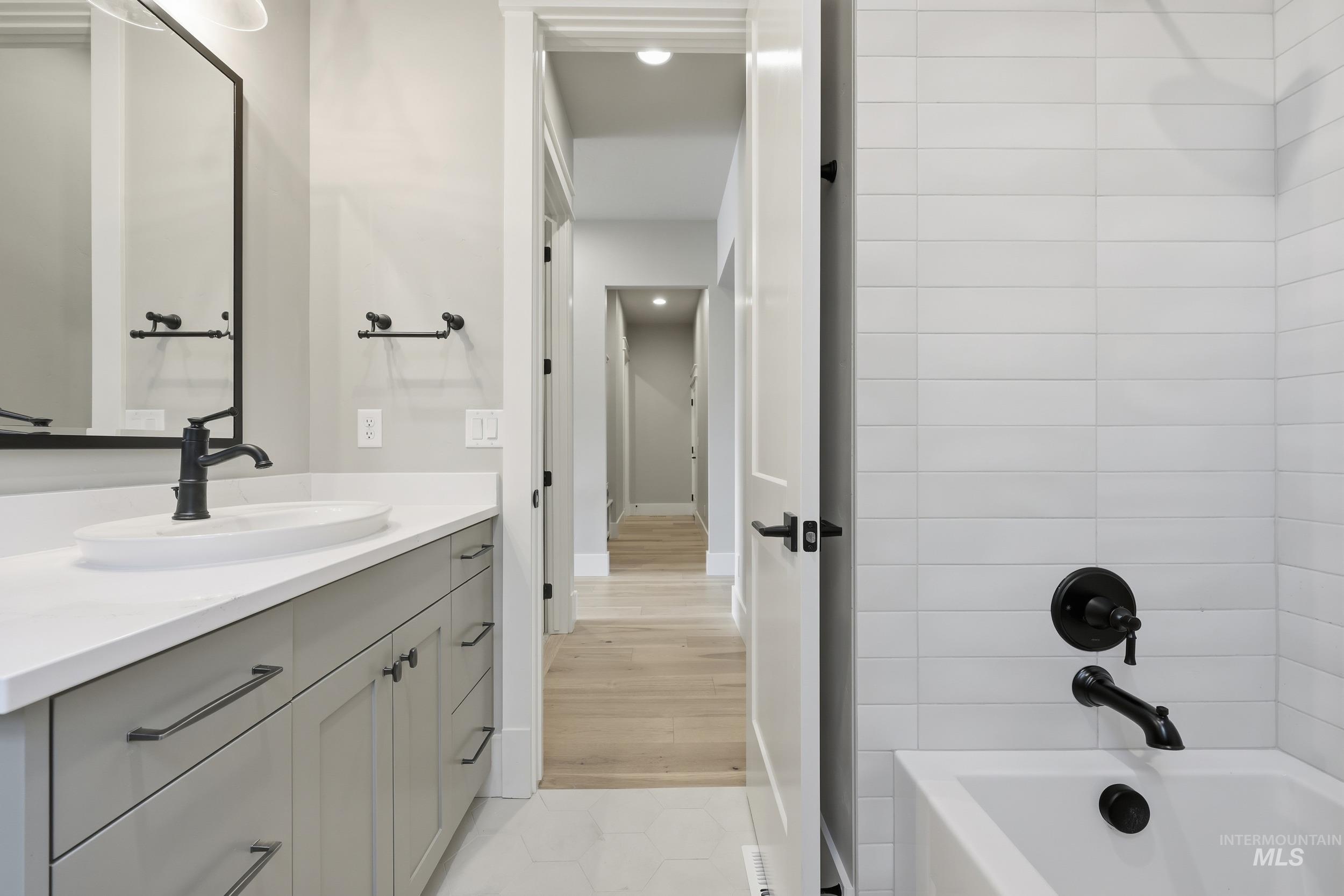 1035 East Crescendo Street Meridian, ID 83642 - Photo 28 of 50 Full bathroom featuring vanity, a bathtub, and light tile patterned floors