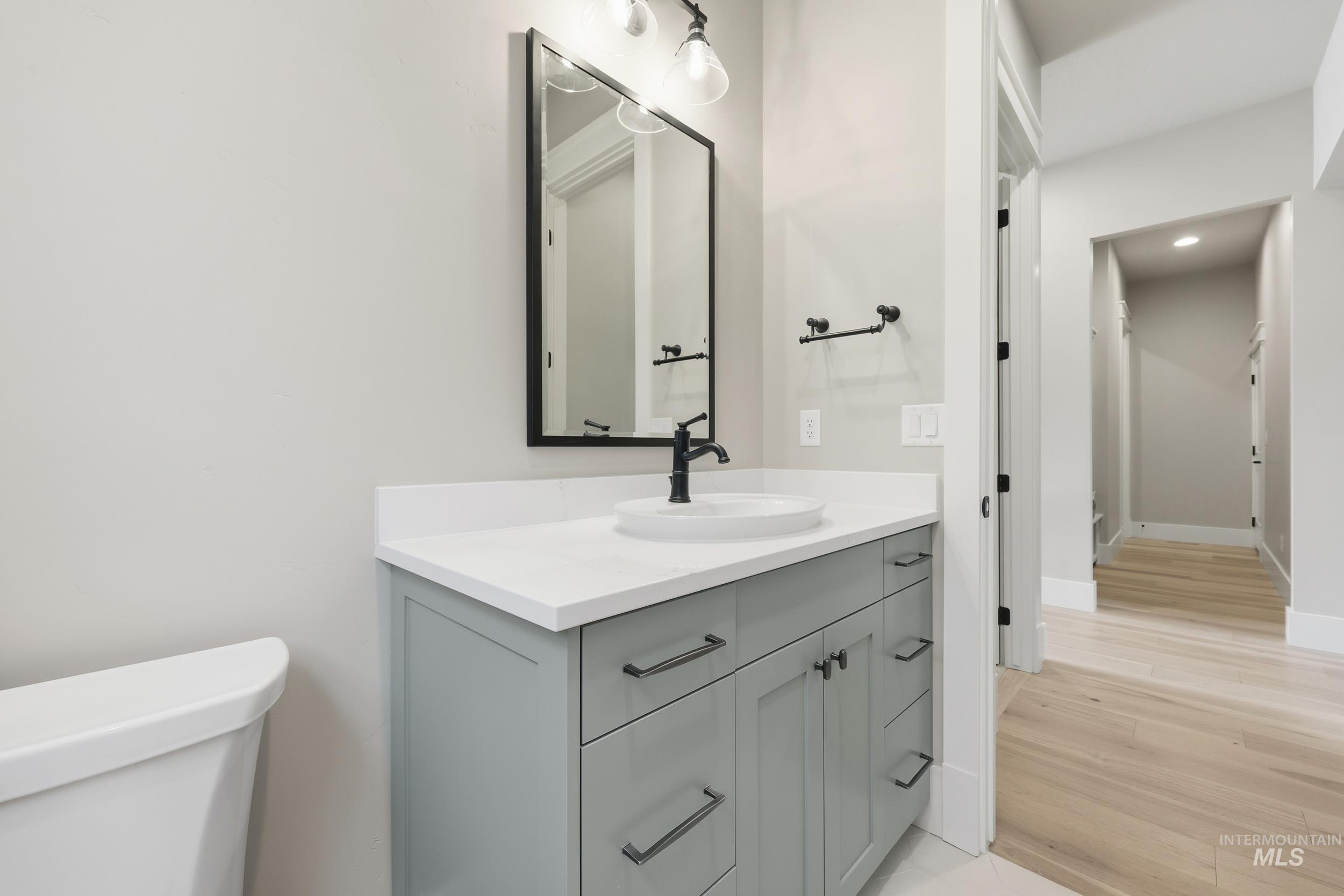 1035 East Crescendo Street Meridian, ID 83642 - Photo 29 of 50 Half bathroom with vanity and light wood-type flooring