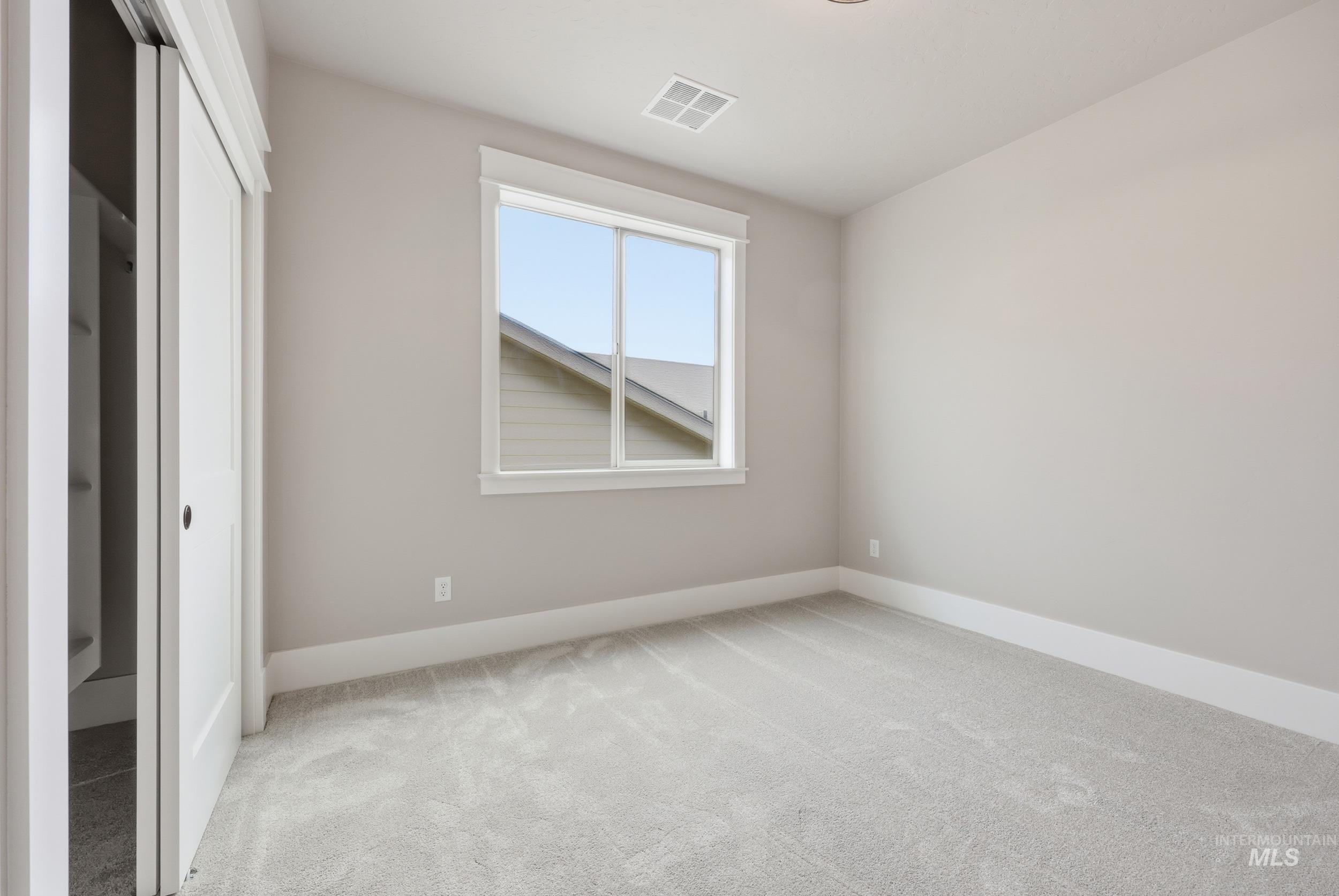 1035 East Crescendo Street Meridian, ID 83642 - Photo 32 of 50 Unfurnished bedroom with light carpet and a closet
