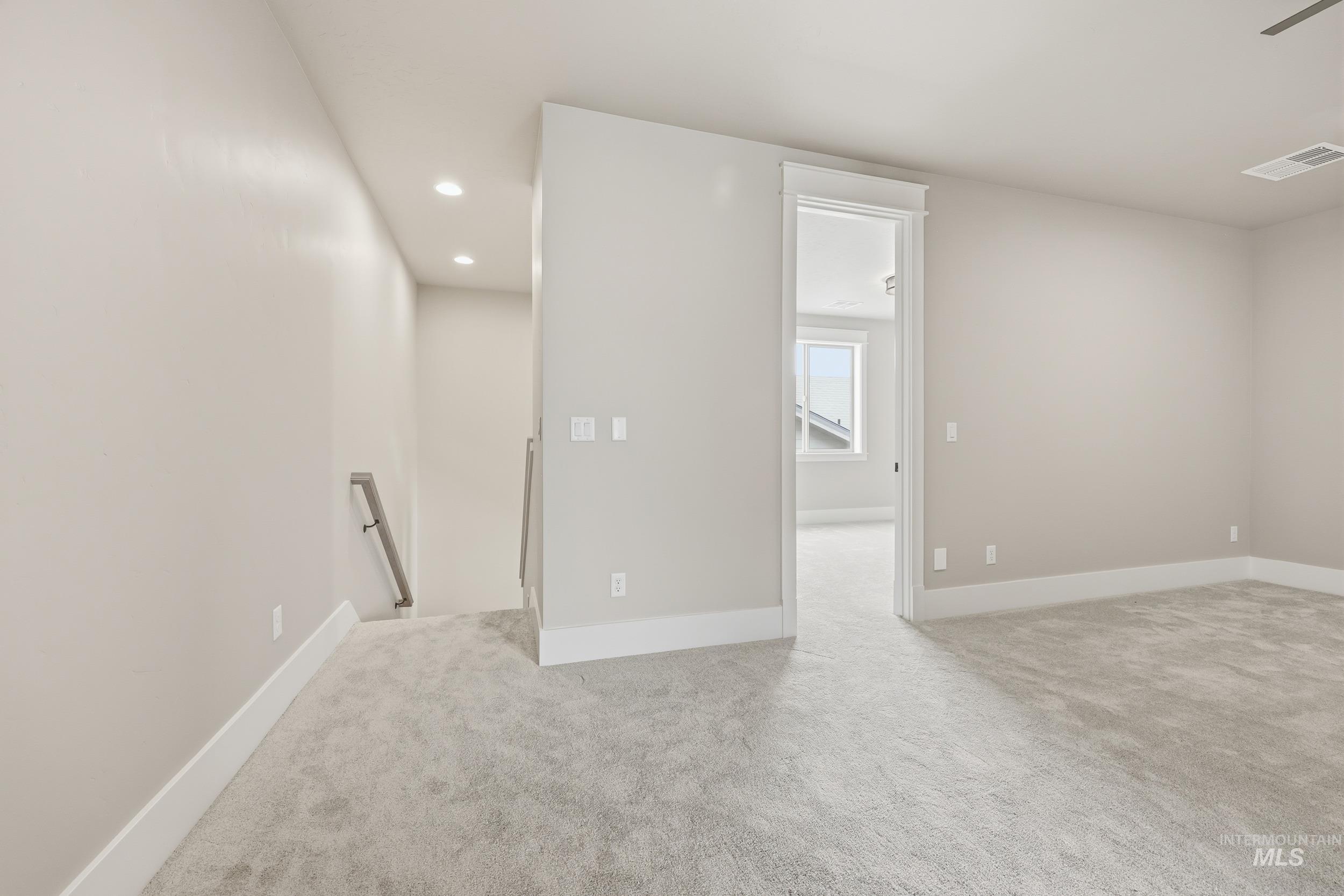 1035 East Crescendo Street Meridian, ID 83642 - Photo 34 of 50 Empty room with light colored carpet and recessed lighting