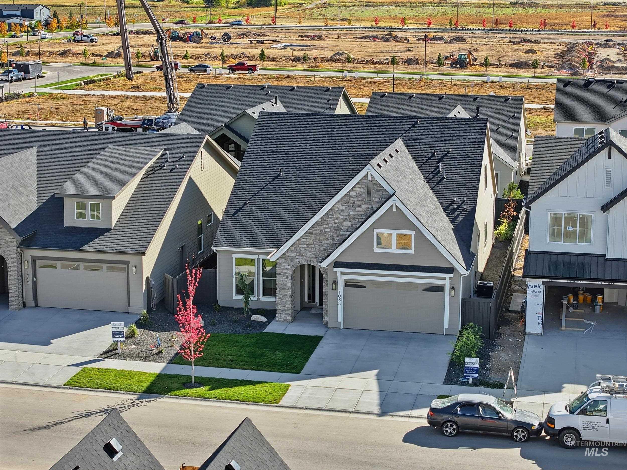1035 East Crescendo Street Meridian, ID 83642 - Photo 44 of 50 View of front of home featuring driveway, a garage, a shingled roof, and stone siding