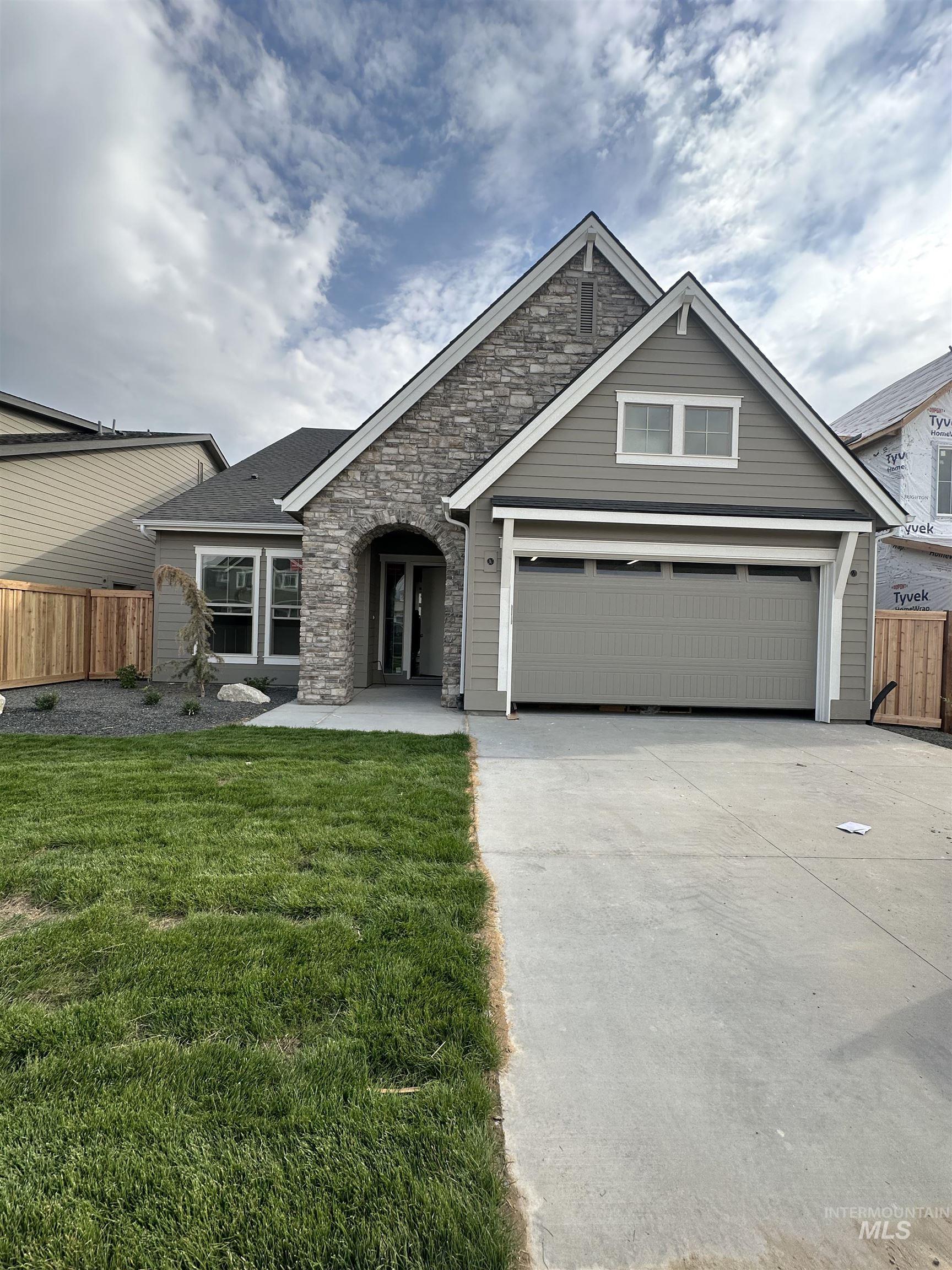1035 East Crescendo Street Meridian, ID 83642 - Photo 50 of 50 View of front facade featuring stone siding, concrete driveway, and a shingled roof
