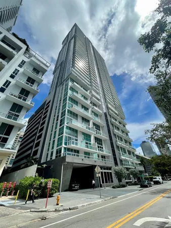a view of a tall building next to a road