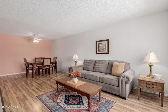 a living room with furniture a table and a lamp