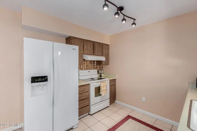 a kitchen with stainless steel appliances a refrigerator and a stove