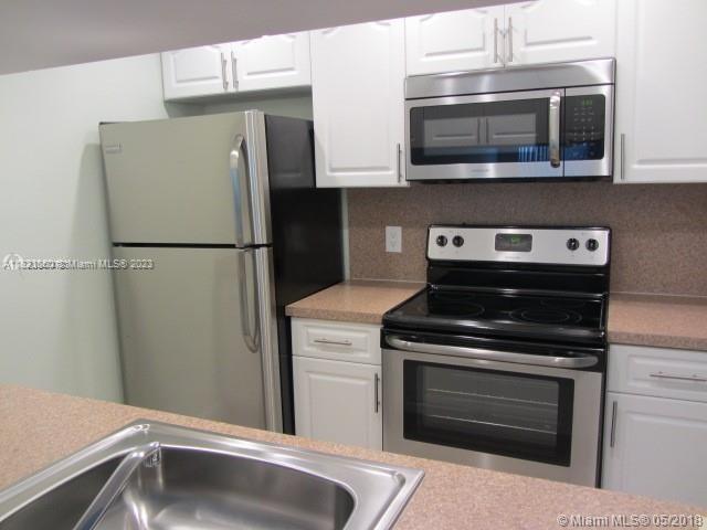 Doral Doral, FL 33166 - Photo 14 of 26 a kitchen with stainless steel appliances a stove microwave and refrigerator