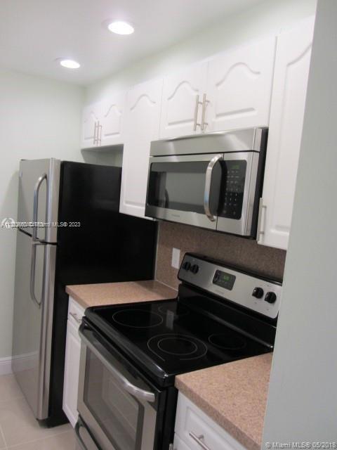Doral Doral, FL 33166 - Photo 15 of 26 a kitchen with a refrigerator stove and microwave