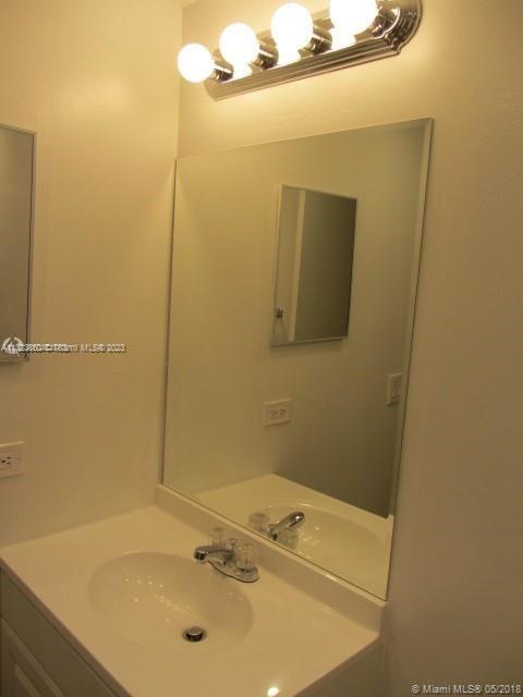 Doral Doral, FL 33166 - Photo 23 of 26 a bathroom with a sink and a mirror