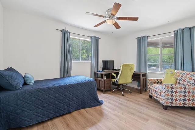 a bedroom with a bed window and couch