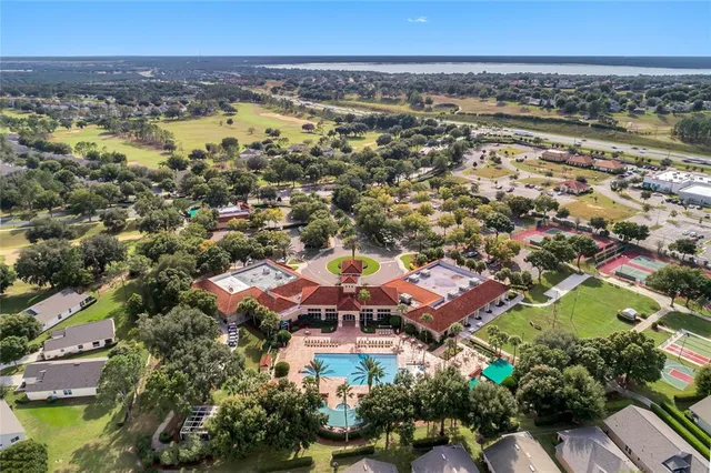 an aerial view of residential houses with swimming pool and outdoor space